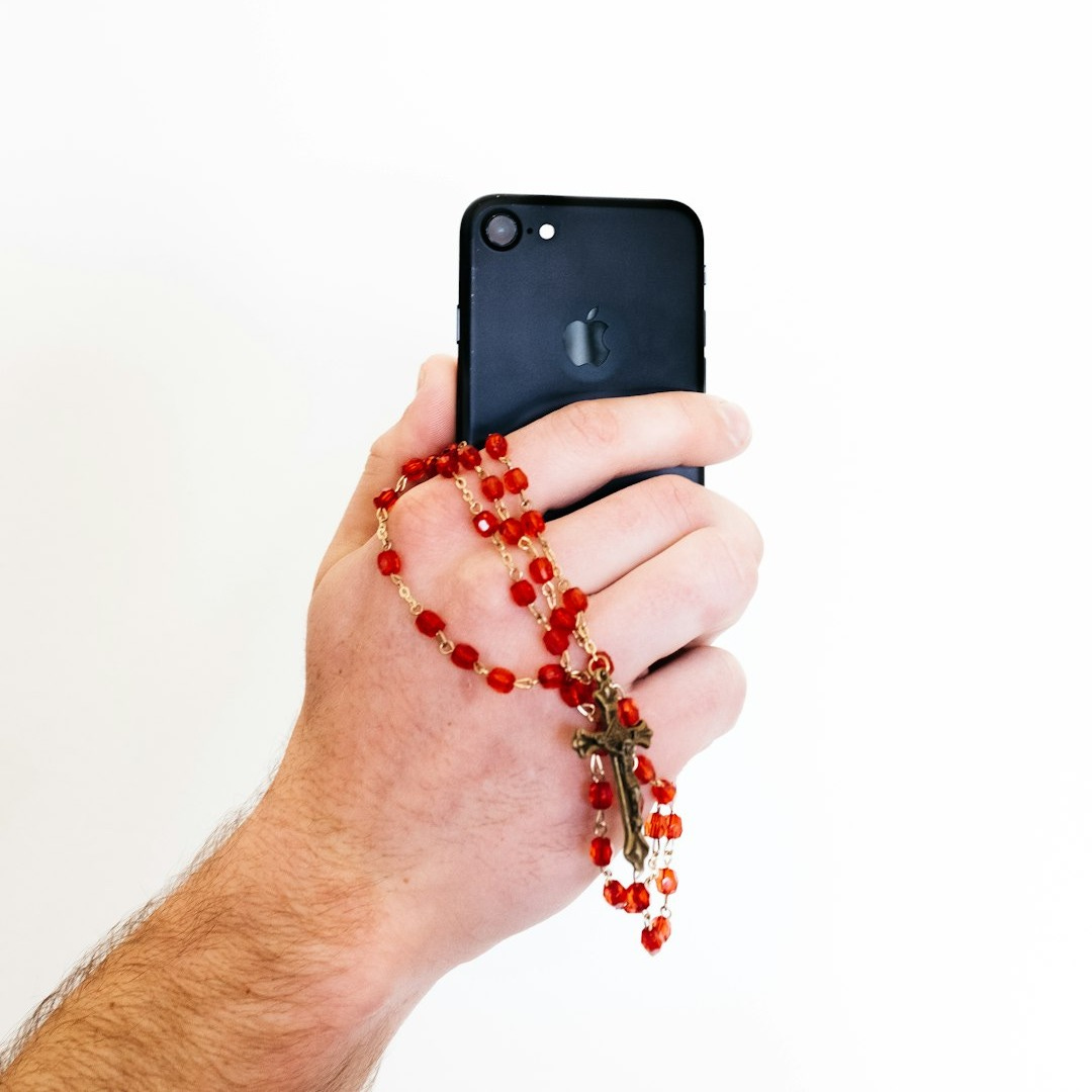 person holding black iphone 5 person holding black iphone 5