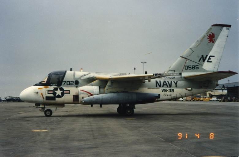 A navy plane on the runway