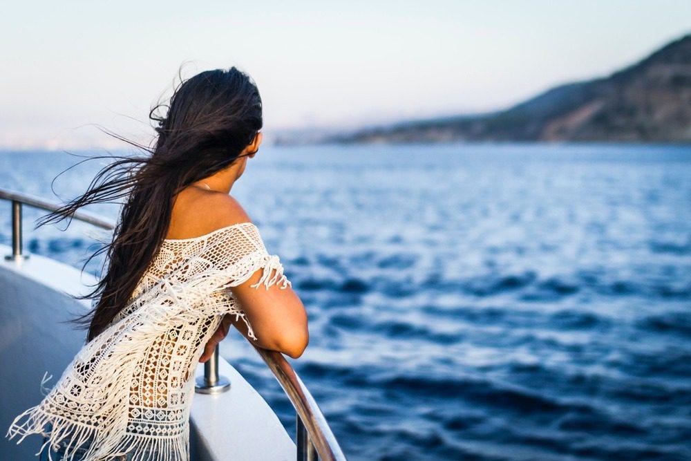 Girl looking over the edge of a cruise ship