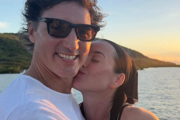 Photo of singer Katy Perry kissing the cheek of former prime minister Justin Trudeau with the sun setting behind them.