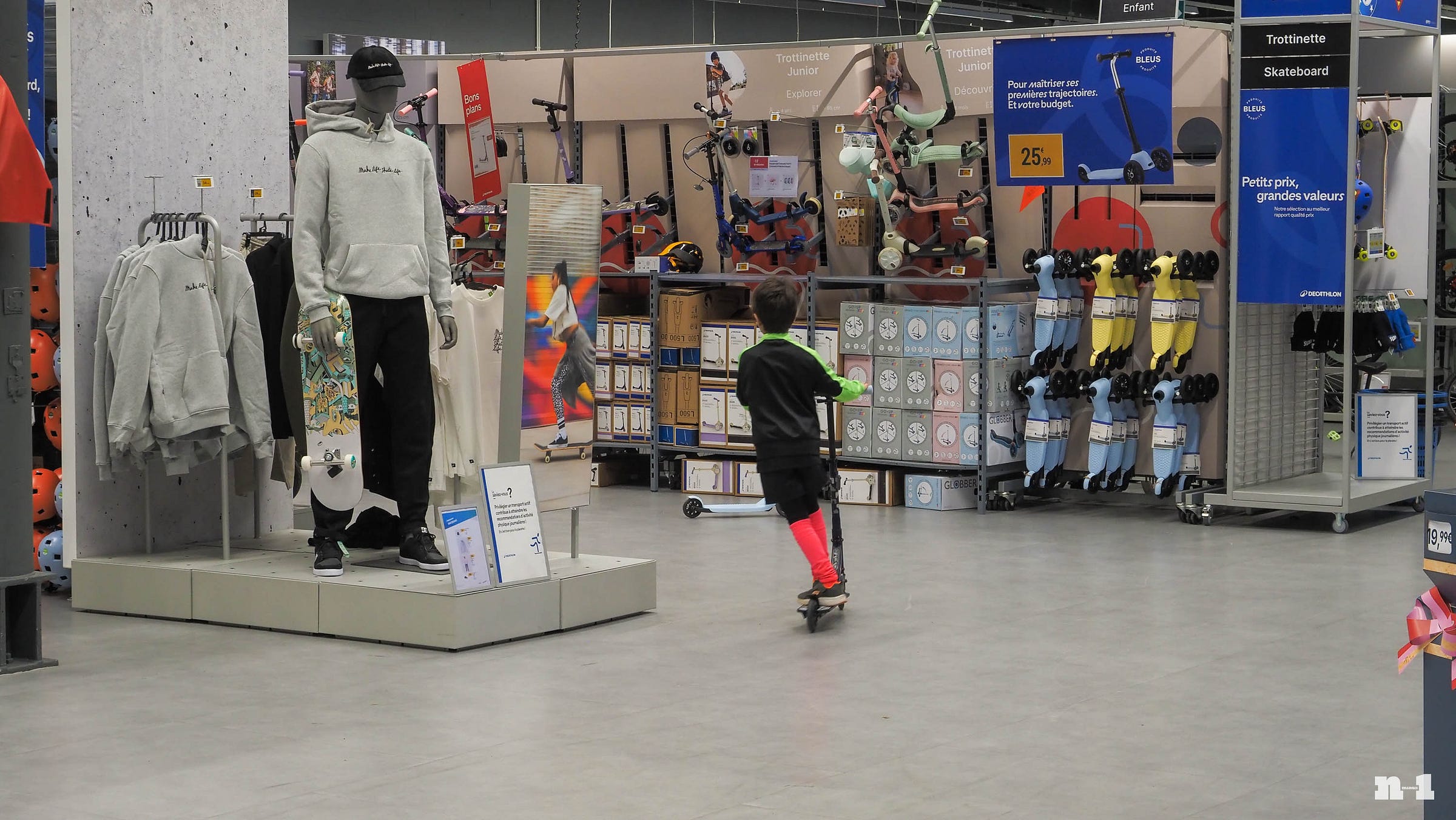 Child riding scooter inside Decathlon store Child riding scooter inside Decathlon store