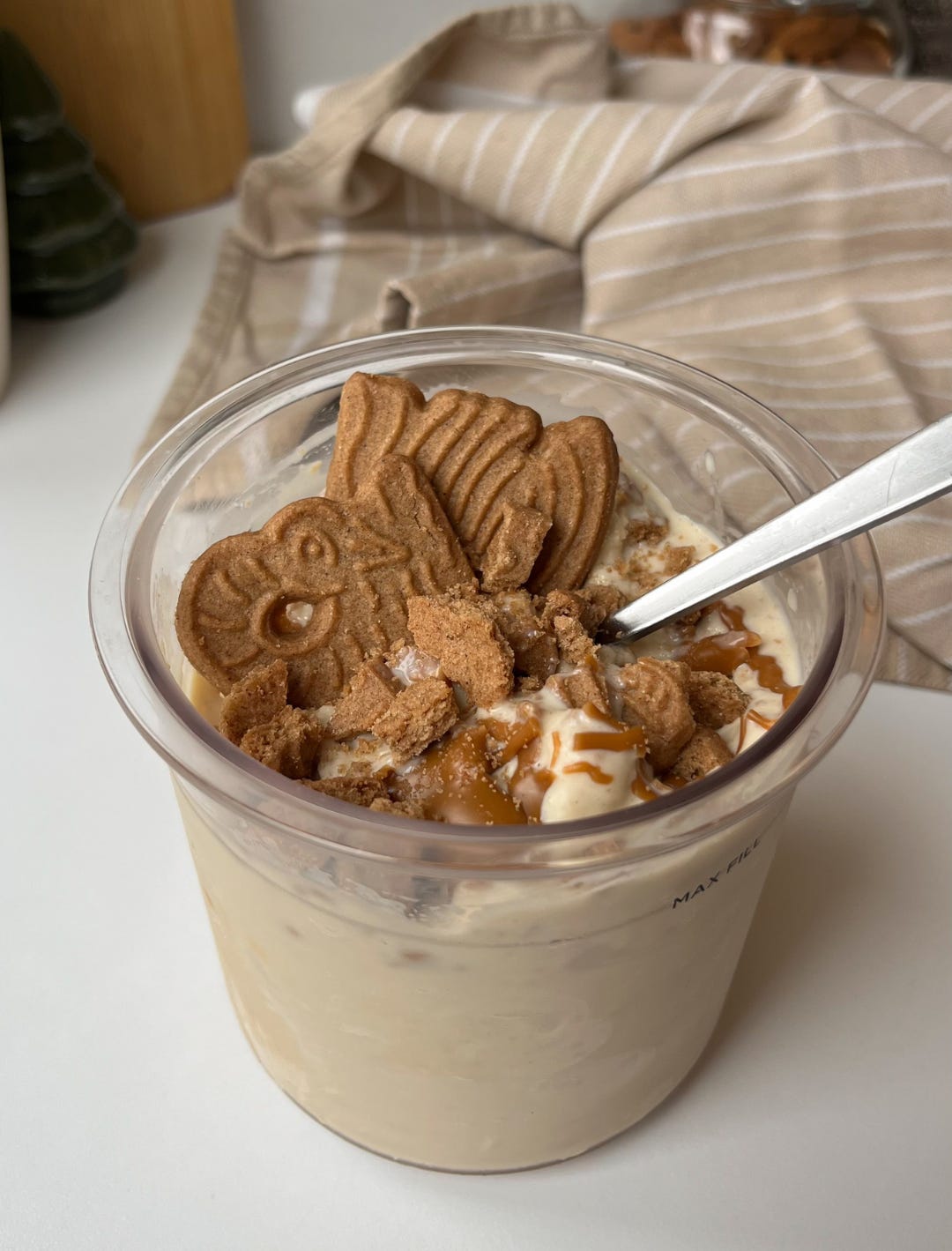 Creamy Speculoos Ninja Creami ice cream topped with Biscoff spread and crushed cookies, perfect for the festive season.