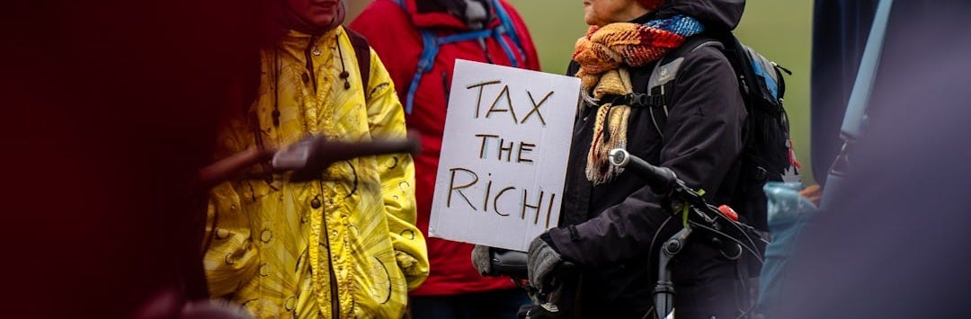 A person in a wheelchair holding a sign