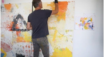 A person painting a wall

Description automatically generated