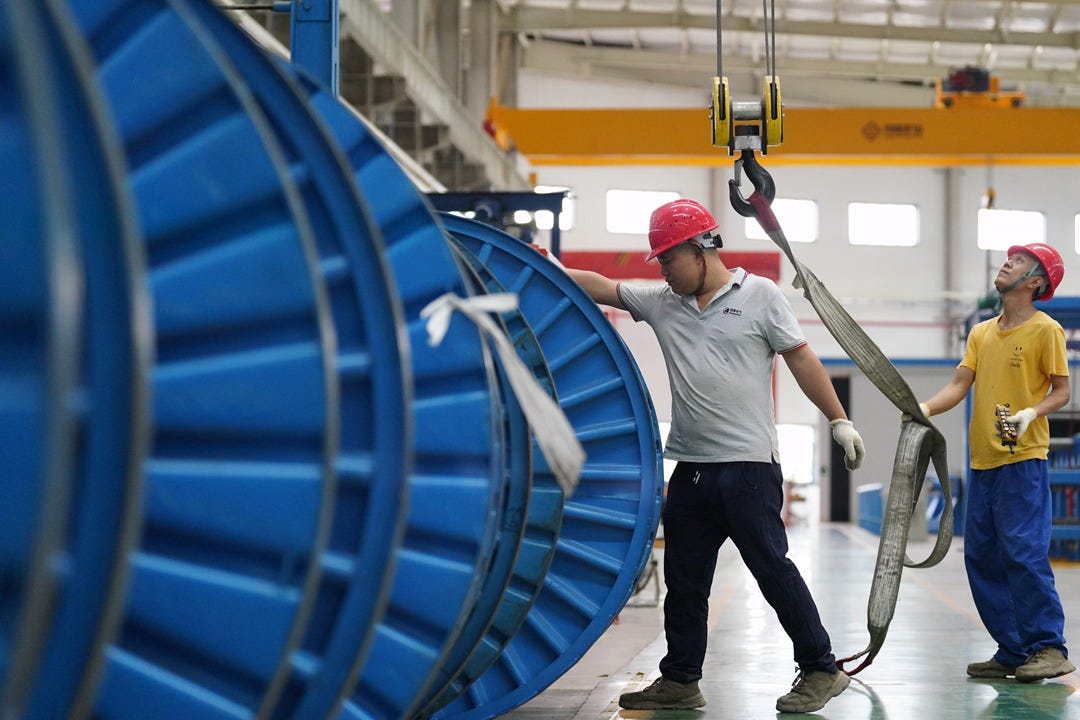 On Aug. 29, in Ezhou, Hubei province, workers install equipment at a manufacturing company. Photo: VCG