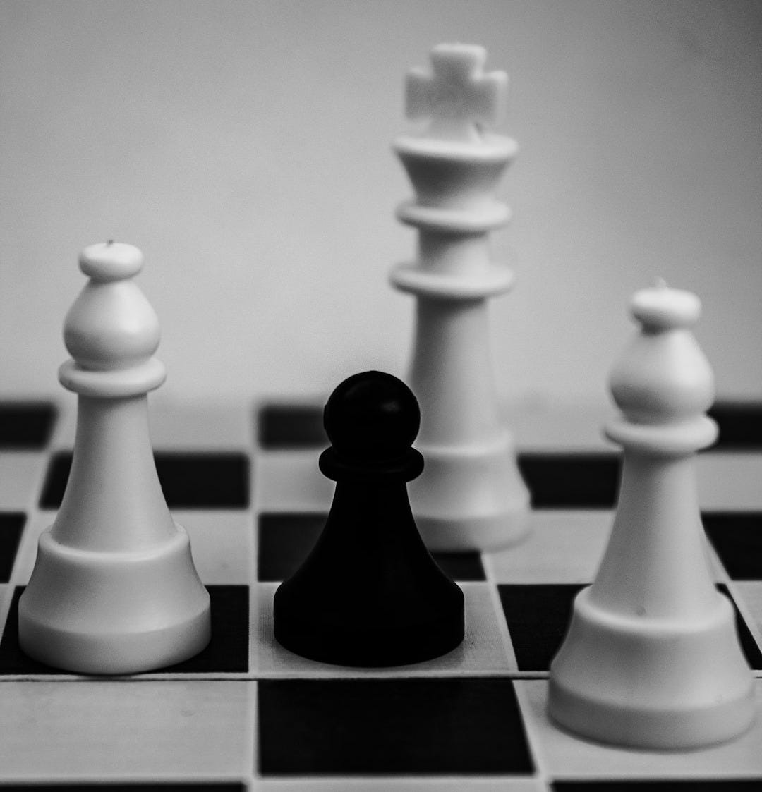 grayscale photo of king, pawn, and bishop chess pieces grayscale photo of king, pawn, and bishop chess pieces