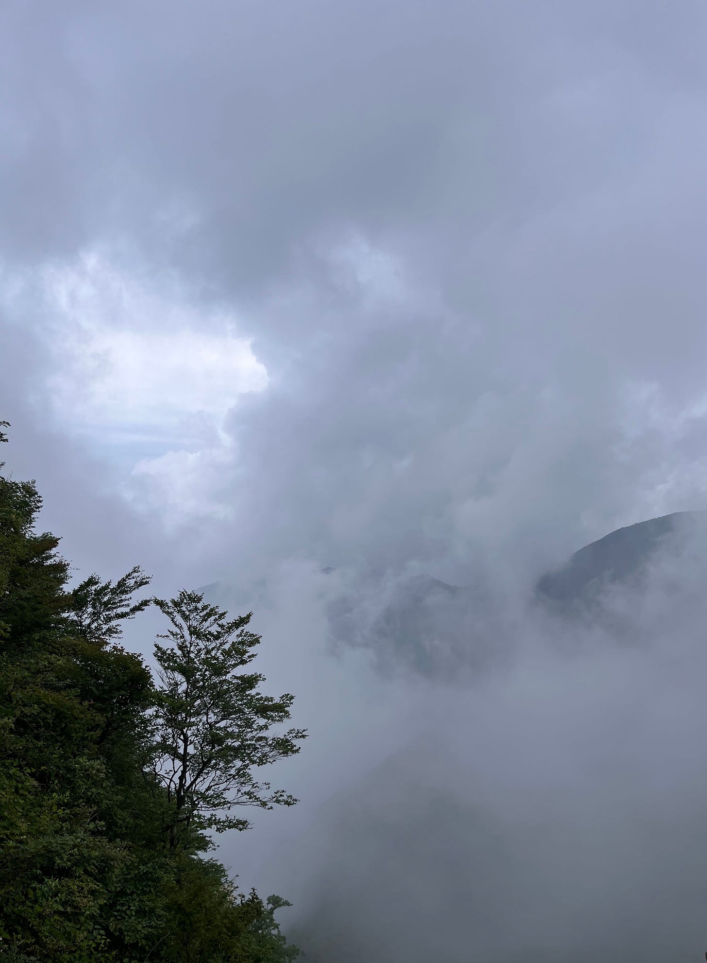 clouds next to a mountain