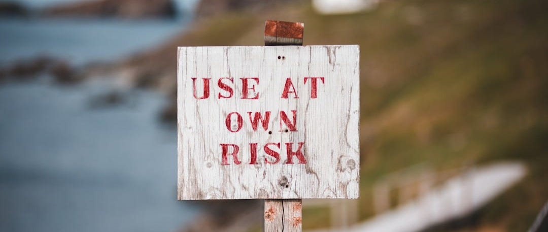 white and red wooden no smoking sign