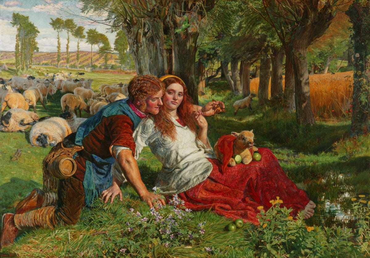 Shepherd and young woman sitting in a golden wheat field with sheep nearby Shepherd and young woman sitting in a golden wheat field with sheep nearby