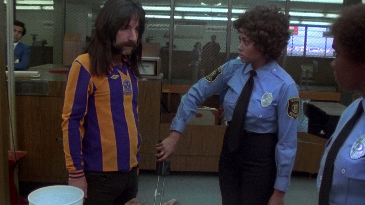 This Is Spinal Tap | Still features Harry Shearer as Derek Smalls with a metal detector pointed towards his crotch.