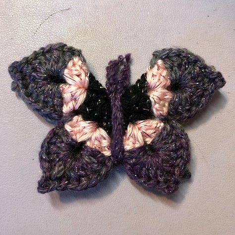Nine multi-coloured crocheted butterflies