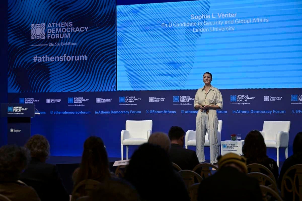 Sophie Vériter speaking on stage at the Athens Democracy Forum
