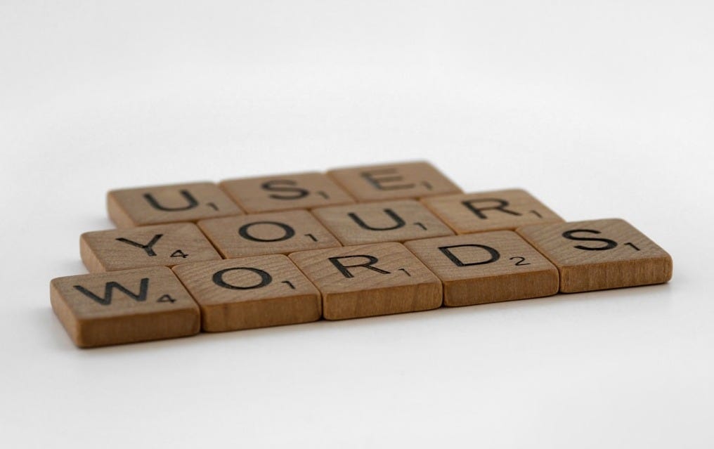 a scrabbled wooden block that says use your words a scrabbled wooden block that says use your words