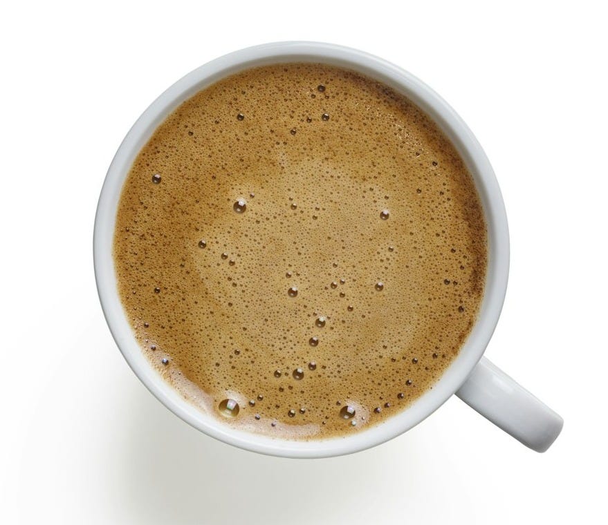 white ceramic mug with brown liquid