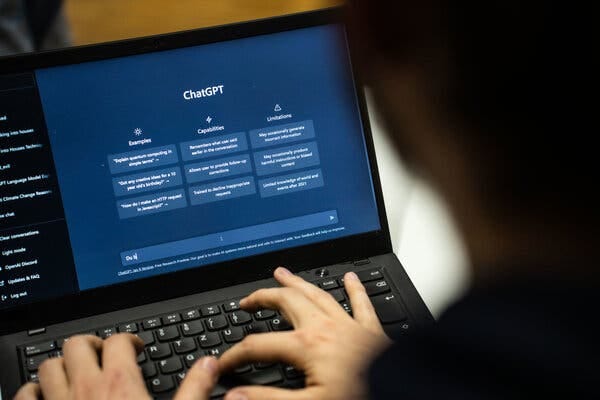 A view over the shoulder of a person typing at a black laptop with a ChatGPT prompt on the screen.