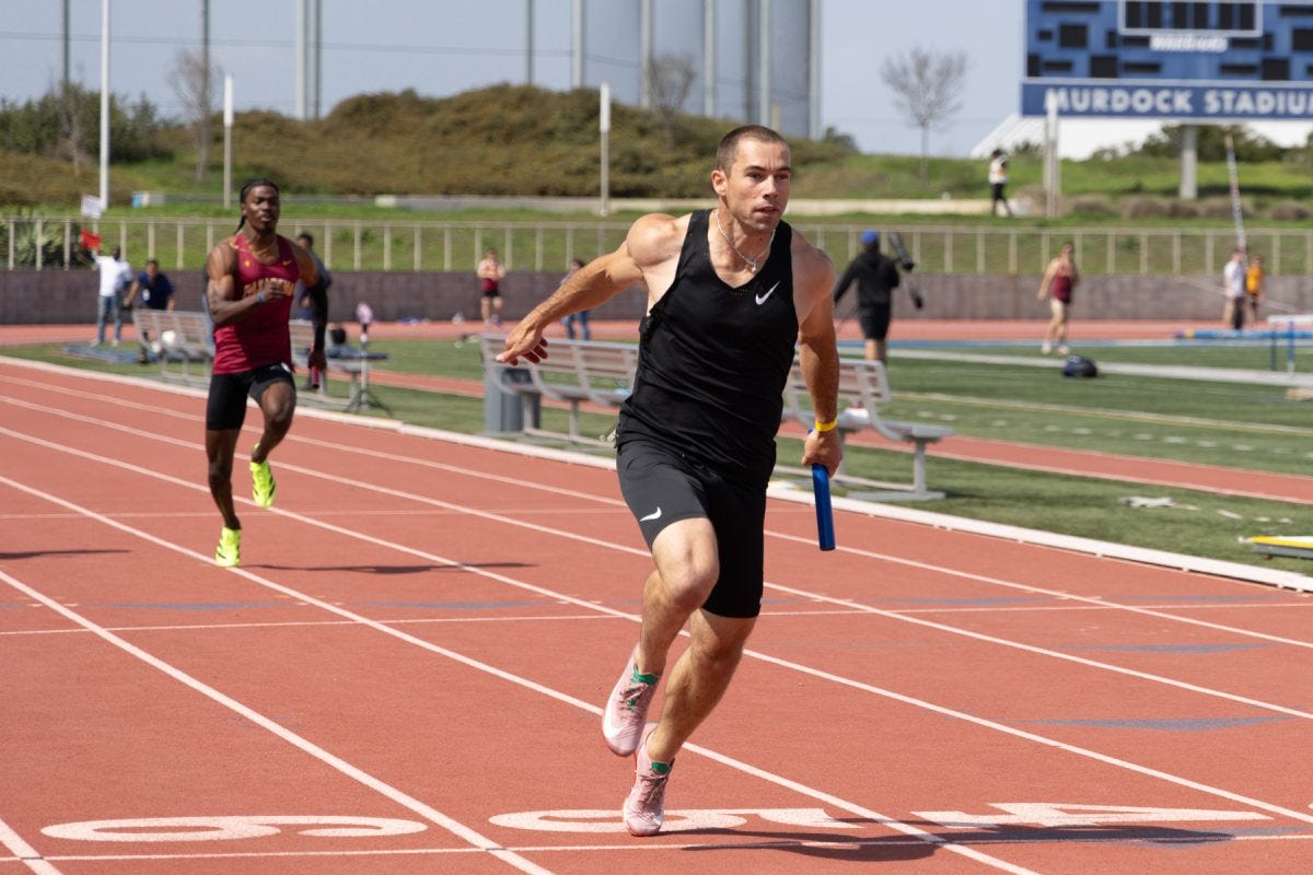 Cody Bidlow from Athlete.X, a running club, crosses the finish line, securing first place in the men’s 4x100-meter relay. It was the club's first time working together, in the weeks leading up to the race the group never practiced hand-offs. (Angel Pasillas | The Union)