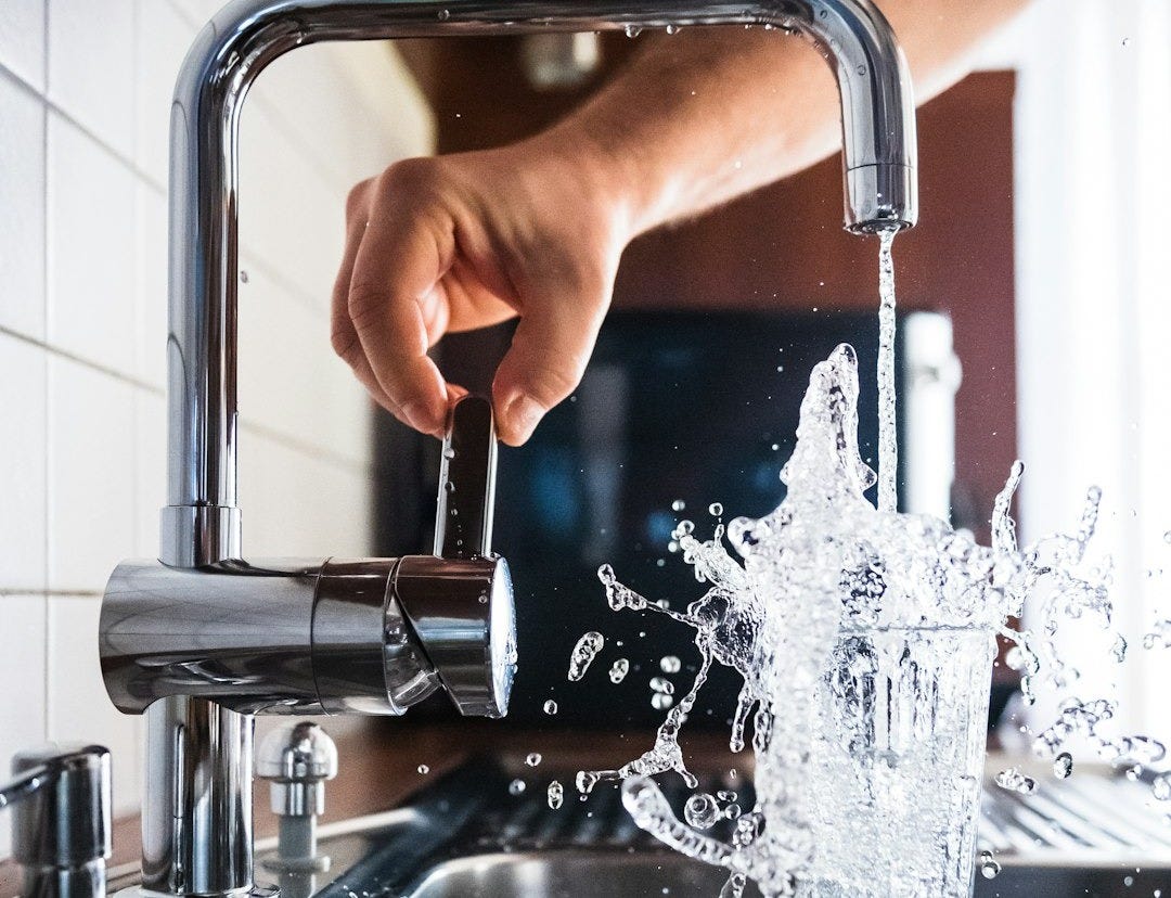 person opening faucet