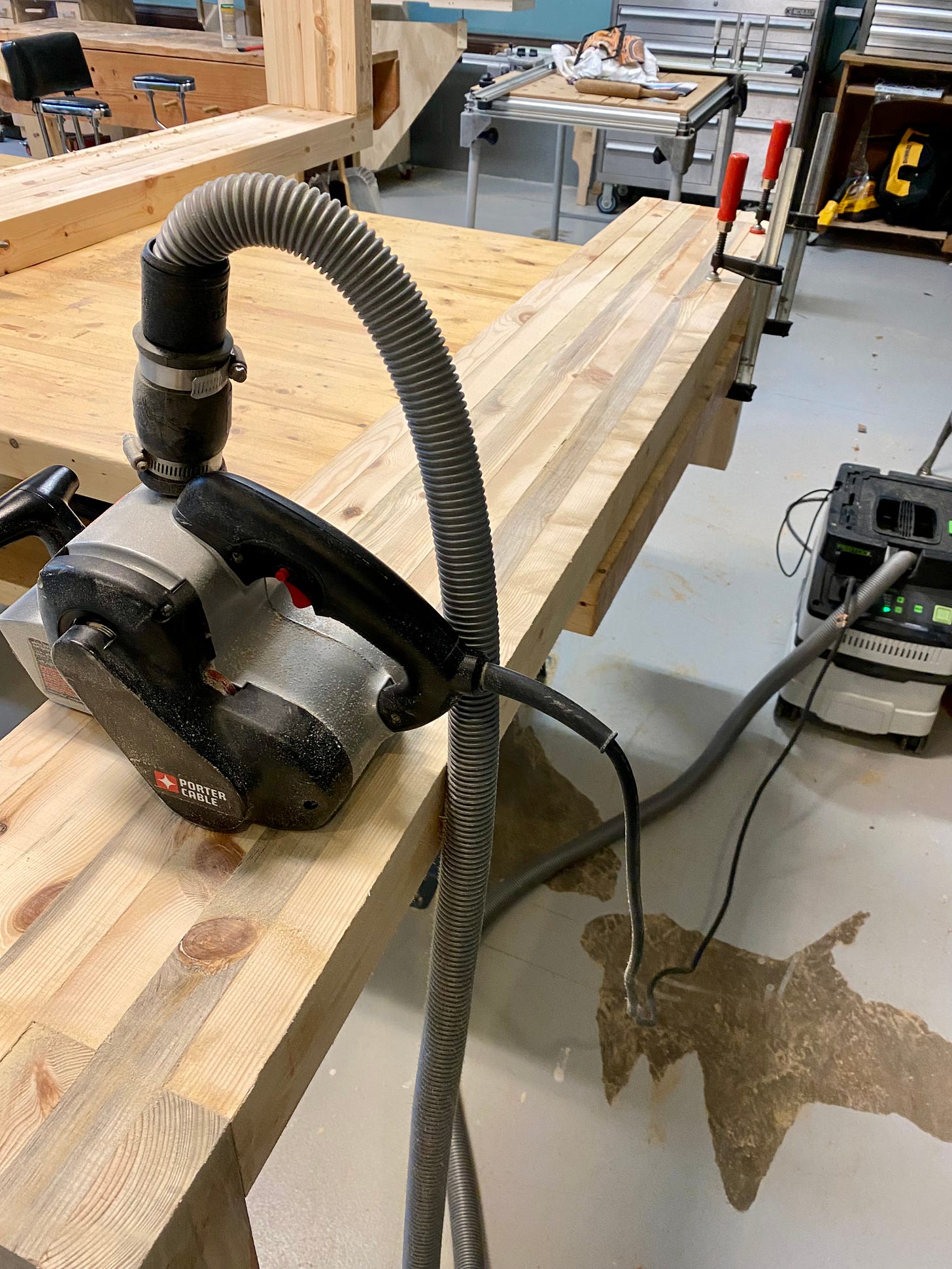 Belt-sanding a wooden bench