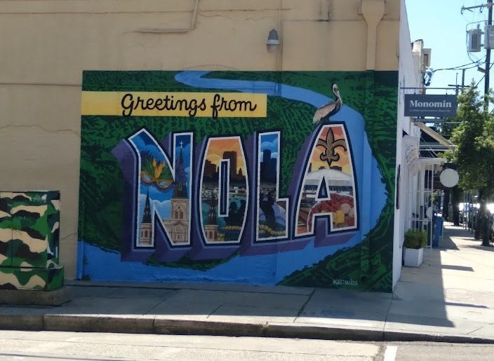 A mural reading "Greetings from NOLA"