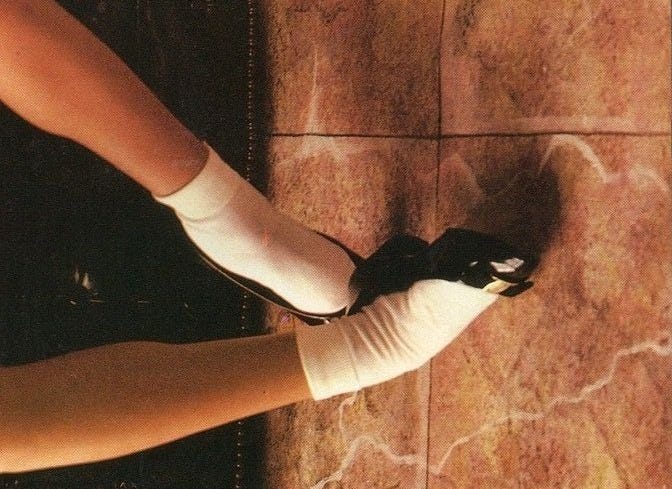 This may contain: a person wearing white socks and black shoes