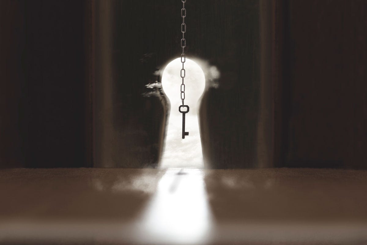 Key Floating over Illuminated Keyhole Key Floating over Illuminated Keyhole