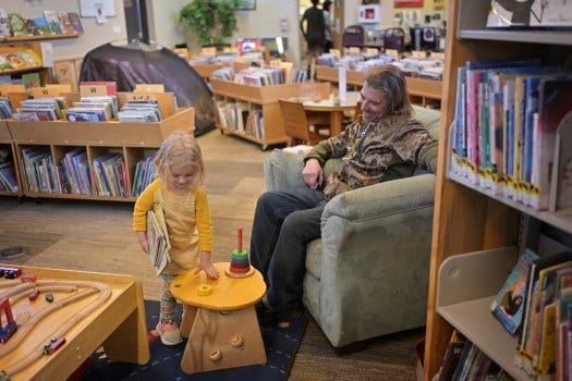 Tallulah Hundley, 4, left, spends time with her father Robert at the Nederland Community Library on Wednesday, April 15, 2025. (Photo by Hyoung Chang/The Denver Post)