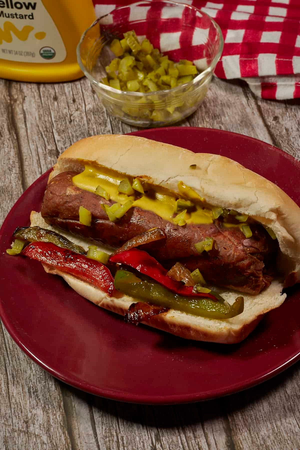 vegan Italian sausage on a bun with grilled onions and peppers