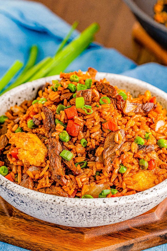 A bowl of beef fried rice topped with scallions. A bowl of beef fried rice topped with scallions.