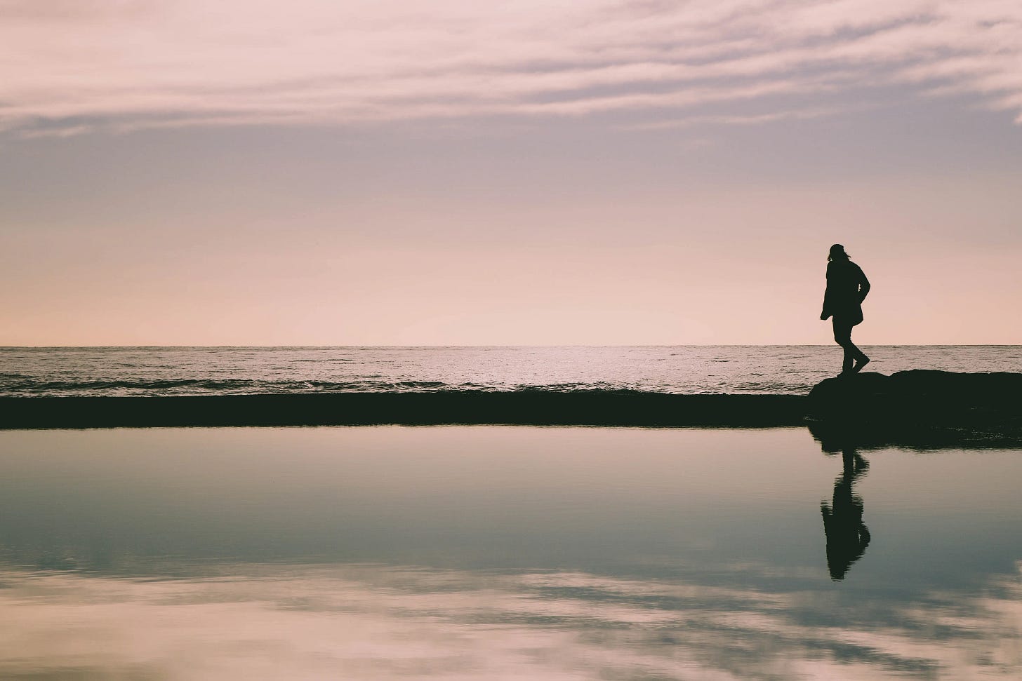 person walking in the dusk