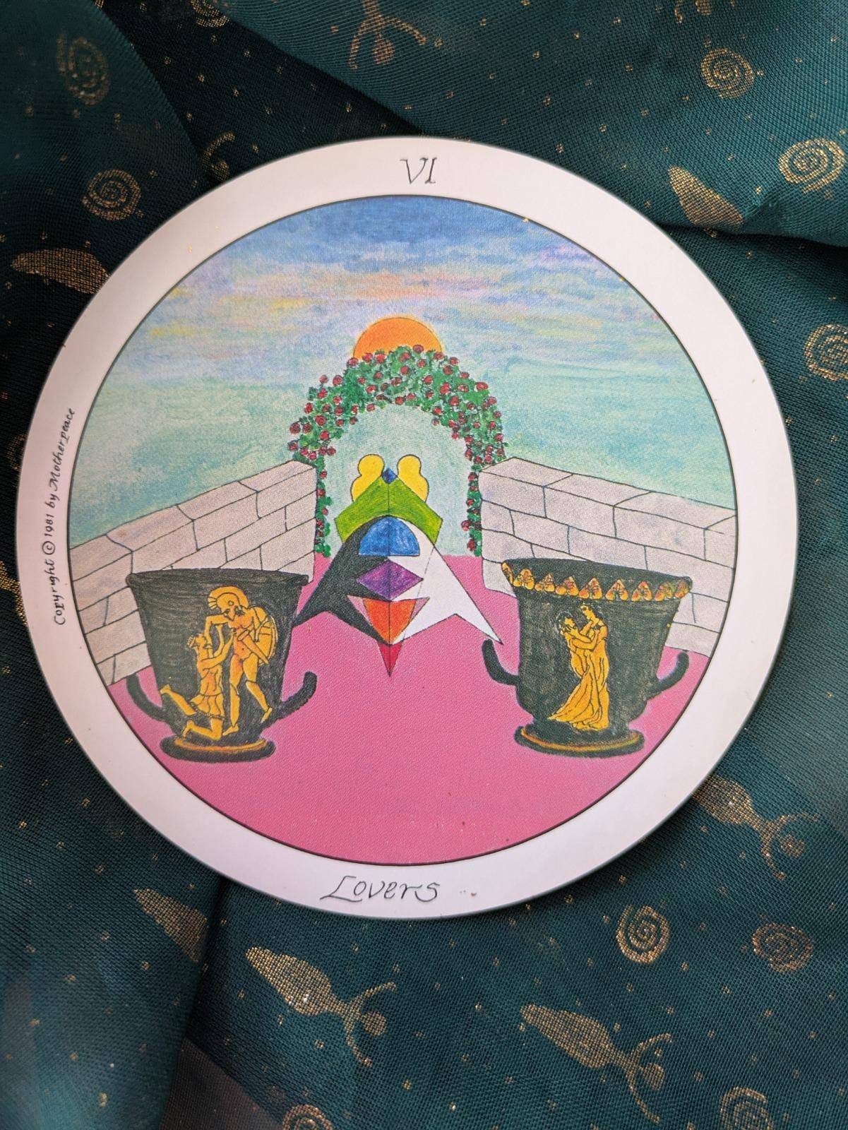 A circular card of The Lovers from the Motherpeace Tarot