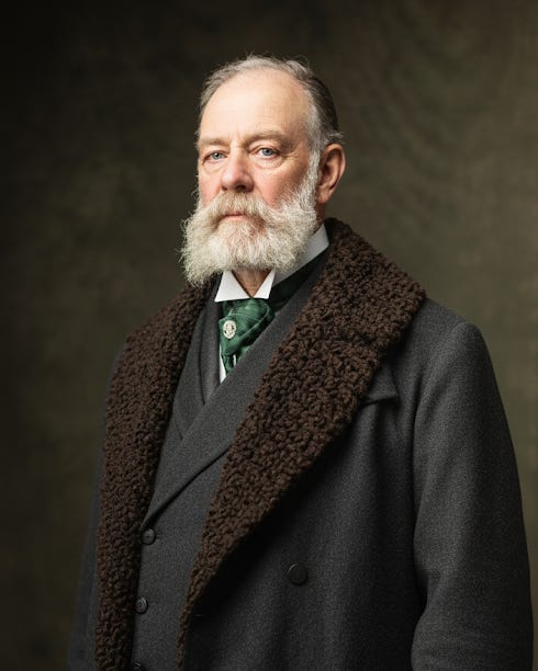 An older man, Charles Coon, with whiskers and wearing a lambswool coat