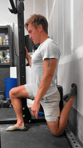 Gif of man demonstrating the couch stretch, but using a wall instead. Gif of man demonstrating the couch stretch, but using a wall instead.