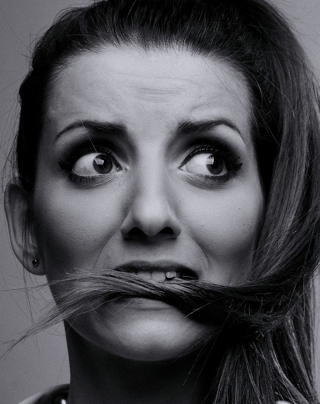 grayscale photo of woman with silver nose ring grayscale photo of woman with silver nose ring