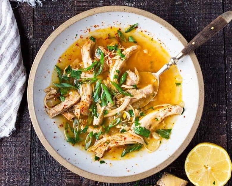 Feel Better Chicken Soup with Lemon and Ginger will warm you to your bones! Brothy and flavorful, this highly-adaptable recipe is the perfect base for your own creations- use whatever grain or starch you prefer- noodles, rice quinoa, beans- or keep it keto and low-carb! Can also be made in an Instant Pot or Slow cooker! #chickensoup #ketosoup #broth