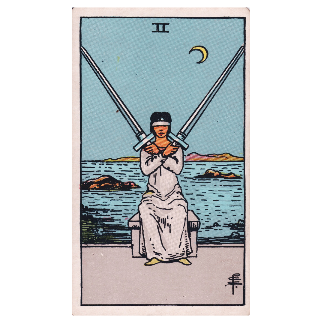 Smith Waite Two of Swords, a blindfolded figure sits with two swords crossed on their chest, water, rocks, and a crescent Moon behind them 