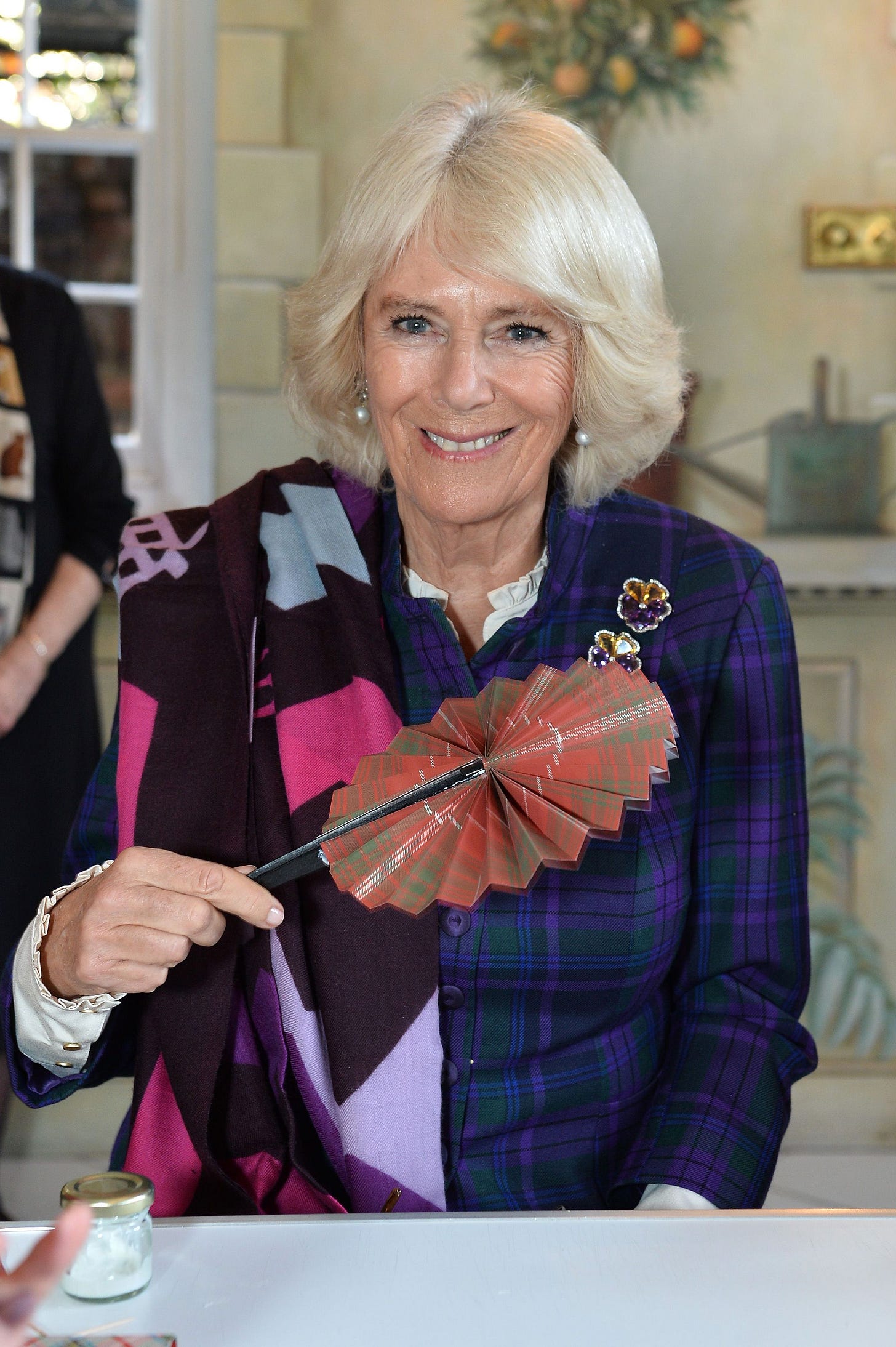Queen Camilla holding a fan at the Fan Museum in Greenwich, 2019