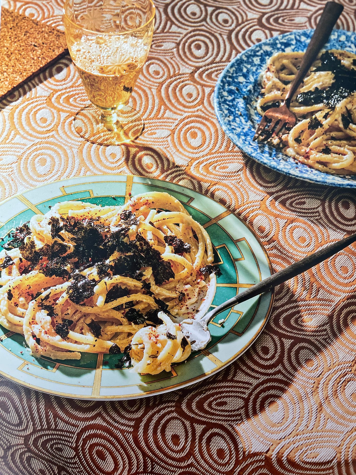 A tangle of bucatini topped with crumbled seaweed