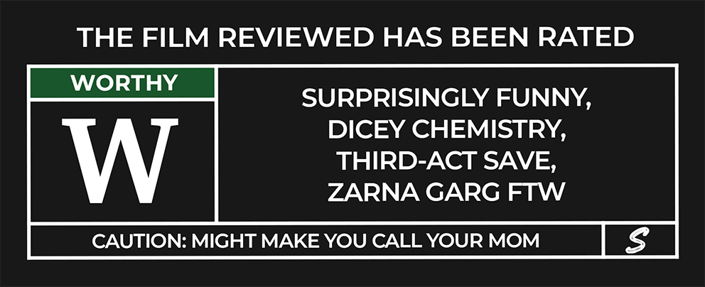 "The film reviewed has been rated." The left column shows a large white “W” under a green label reading “WORTHY.” The right column lists: “Surprisingly Funny, Dicey Chemistry, Third-Act Save, Zarna Garg FTW.” A caution bar below reads: “Caution: Might Make You Call Your Mom.”