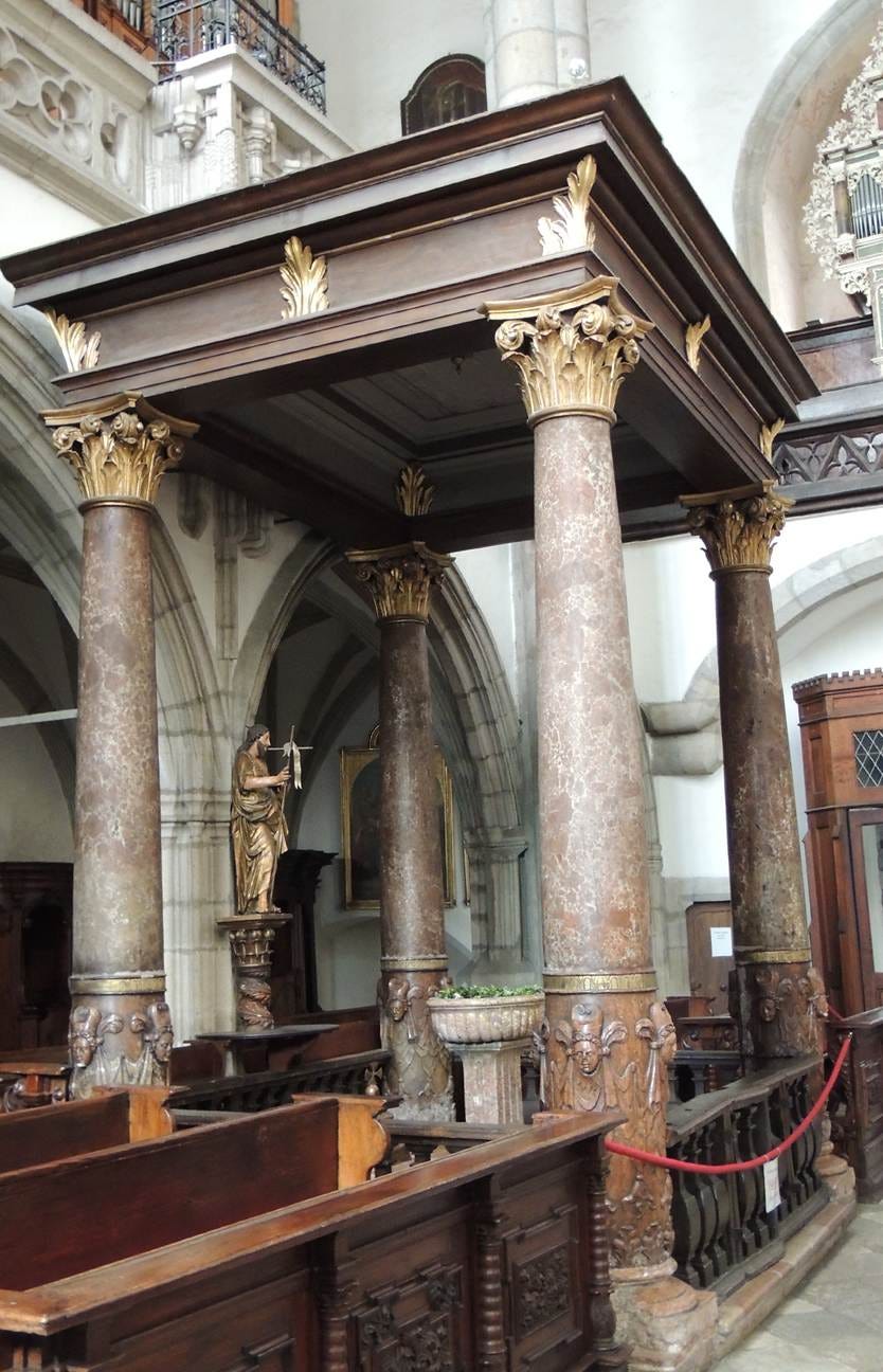 A large wooden structure with columns

AI-generated content may be incorrect.