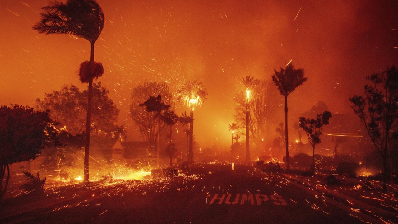 Thousands of Los Angeles residents forced to flee as winds stoke raging  wildfires
