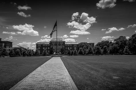 Mississippi State football stadium, campus with American flag, cowbell