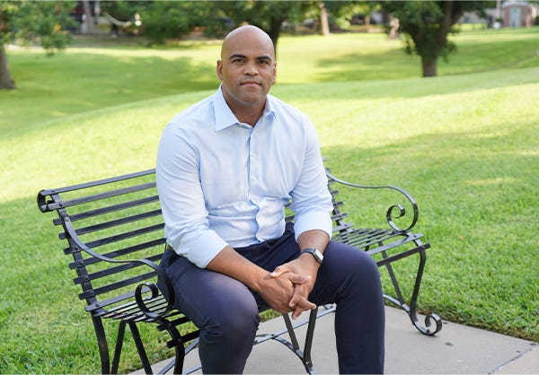 Colin Allred sitting on a bench.