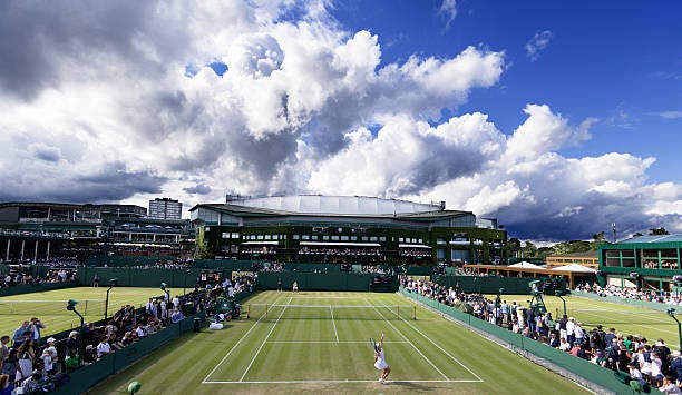 Clouds gather on a stormy day as junior matches take place on the outside courts during the Wimbledon Lawn Tennis Championships at the All England...