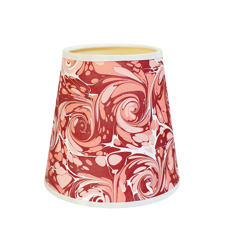 a ceramic wall light, a brown lamp with cream fabric shade, a marble lampshade, a vintage terracotta lamp 