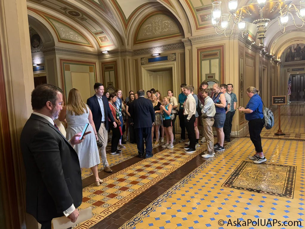 Man on phone while a politician addresses constituents in US Capitol. © AskaPolUAPs.com Man on phone while a politician addresses constituents in US Capitol. © AskaPolUAPs.com