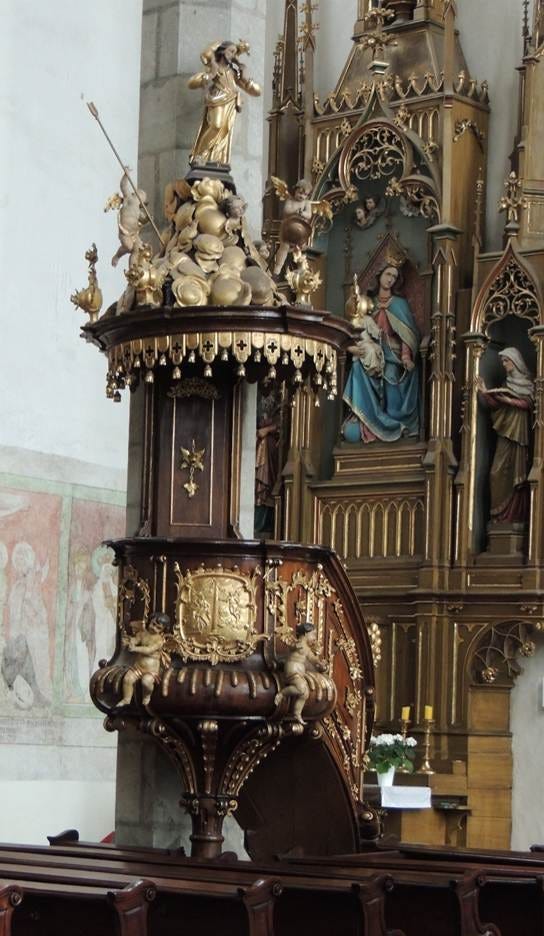 A gold and bronze object in a church

AI-generated content may be incorrect.
