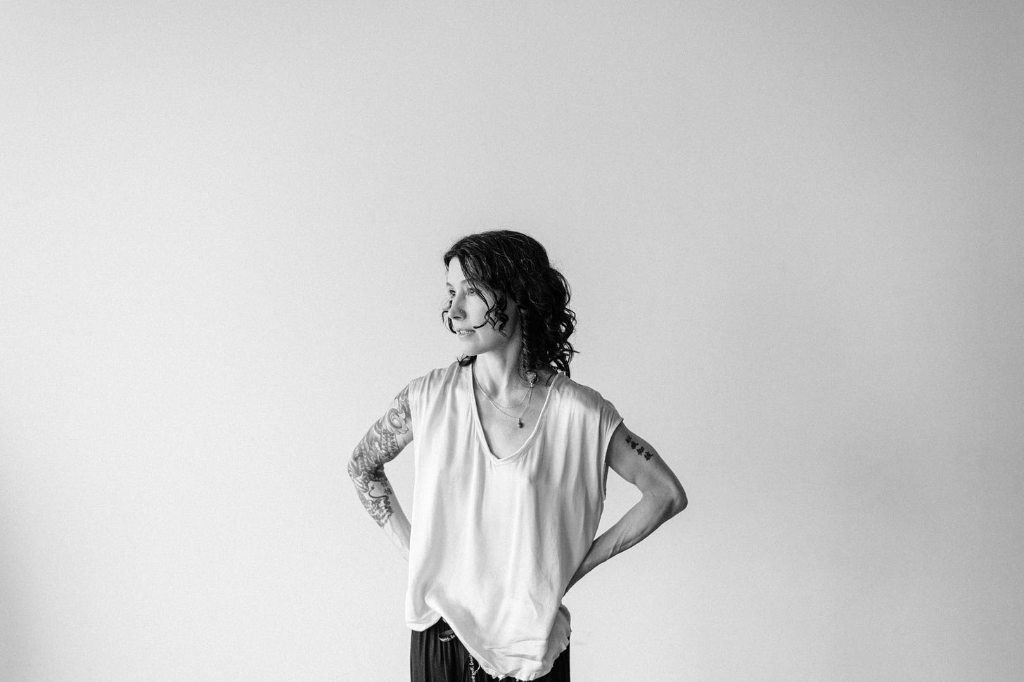 author standing with hands on hips looking into distance