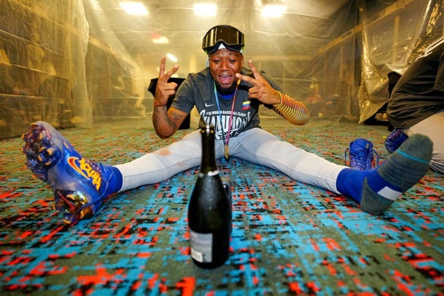 Ronald Acuña Jr. celebrating Venezuela's World Baseball Classic title by  himself in the clubhouse, using a champagne bottle to prop his phone up :  r/baseball