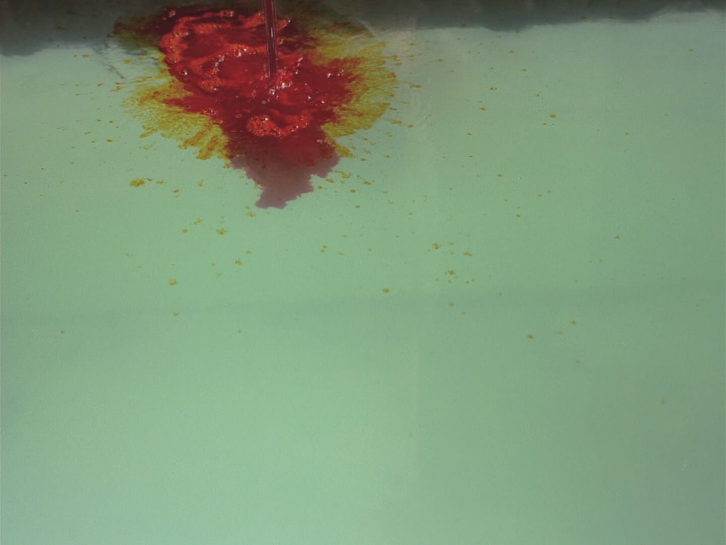 Red dye spills into light green water in "Ju Dou" (1990), a very good movie about, among other things, textiles