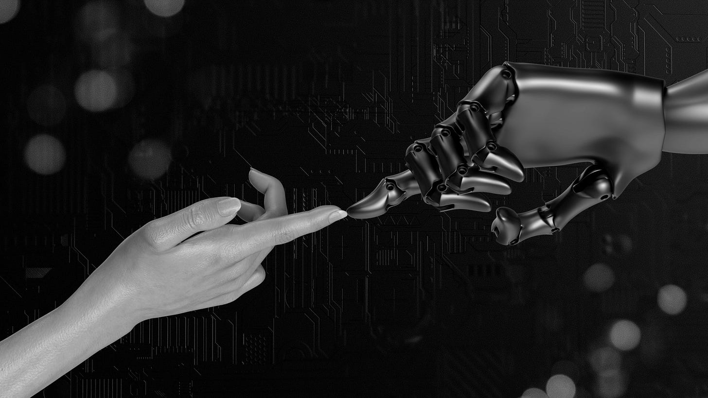 A human hand reaches out to a robot hand.